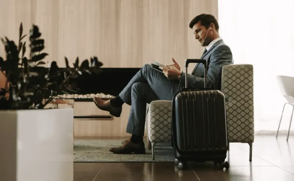 Businessman reading magazine in airport waiting room
